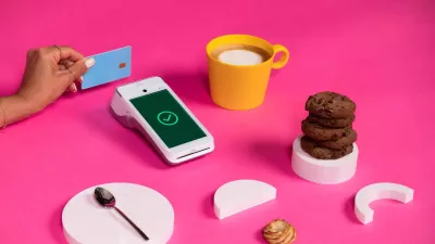 Android payment terminal next to coffee, cookies, and white shapes Android payment terminal next to coffee, cookies, and white shapes