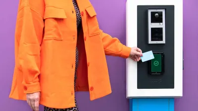 Person paying at a parking ticket machine Person paying at a parking ticket machine